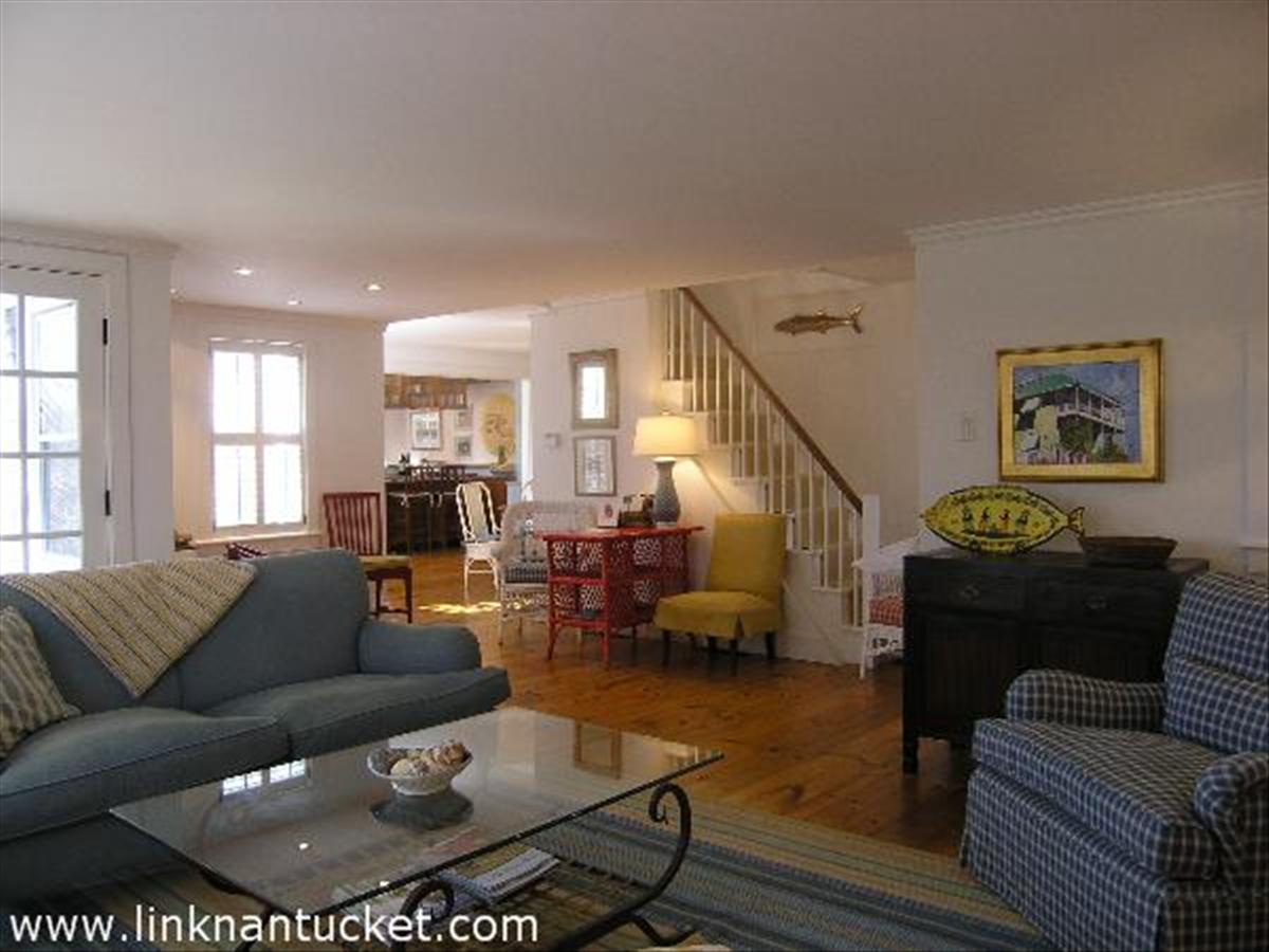 34 R Cliff Road Nantucket, MA 02554 - Photo 3 of 14 a living room with furniture couches and a dining table with wooden floor