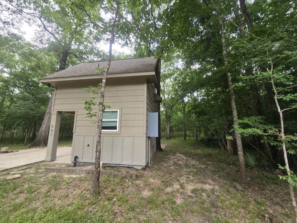 667 Miller Drive Cleveland, TX 77327 - Photo 2 of 25 a backyard of a house with plants and tree