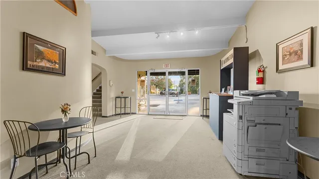 a living room with furniture a flat screen tv and a table