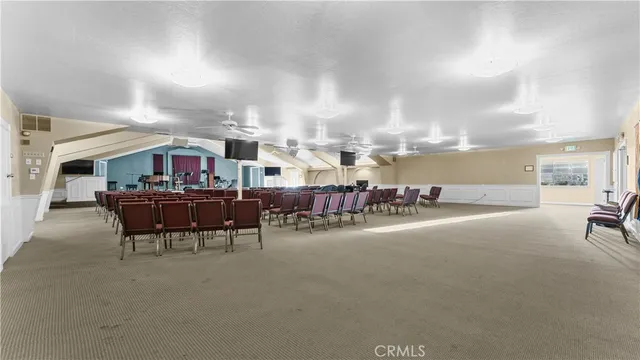 a living room with lots of furniture and clutter