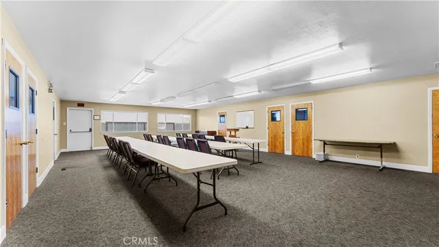 a living room with lots of furniture a rug and a piano