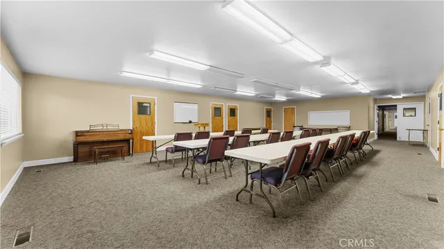 a view of a dining area with furniture and a window