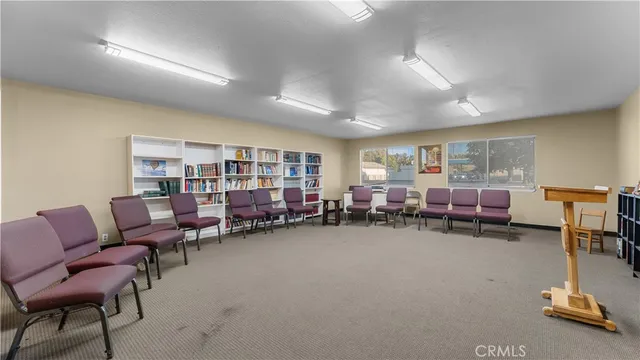 a view of a house with a yard and sitting area
