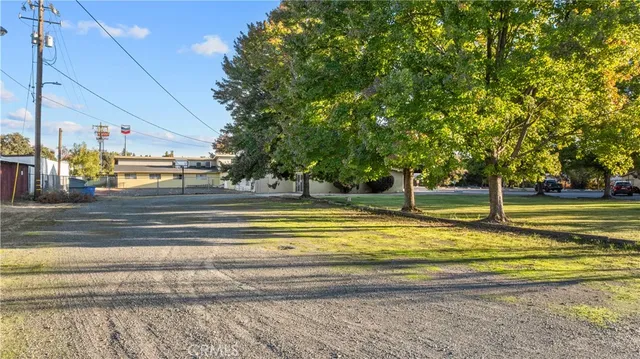 a view of swimming pool with outdoor space and trees in the background