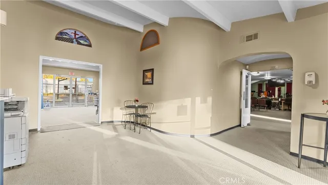 a bedroom with furniture and a large window