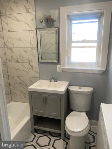a bathroom with a sink toilet and bathtub