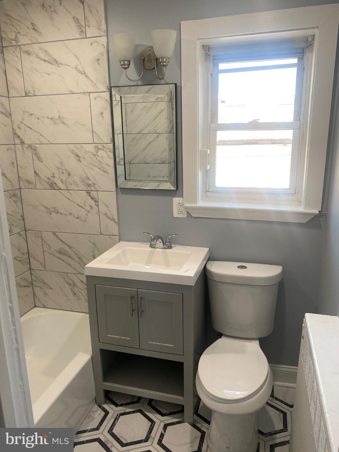 6254 Everett Street, Unit 3 Philadelphia, PA 19149 - Photo 6 of 8 a bathroom with a sink toilet and bathtub
