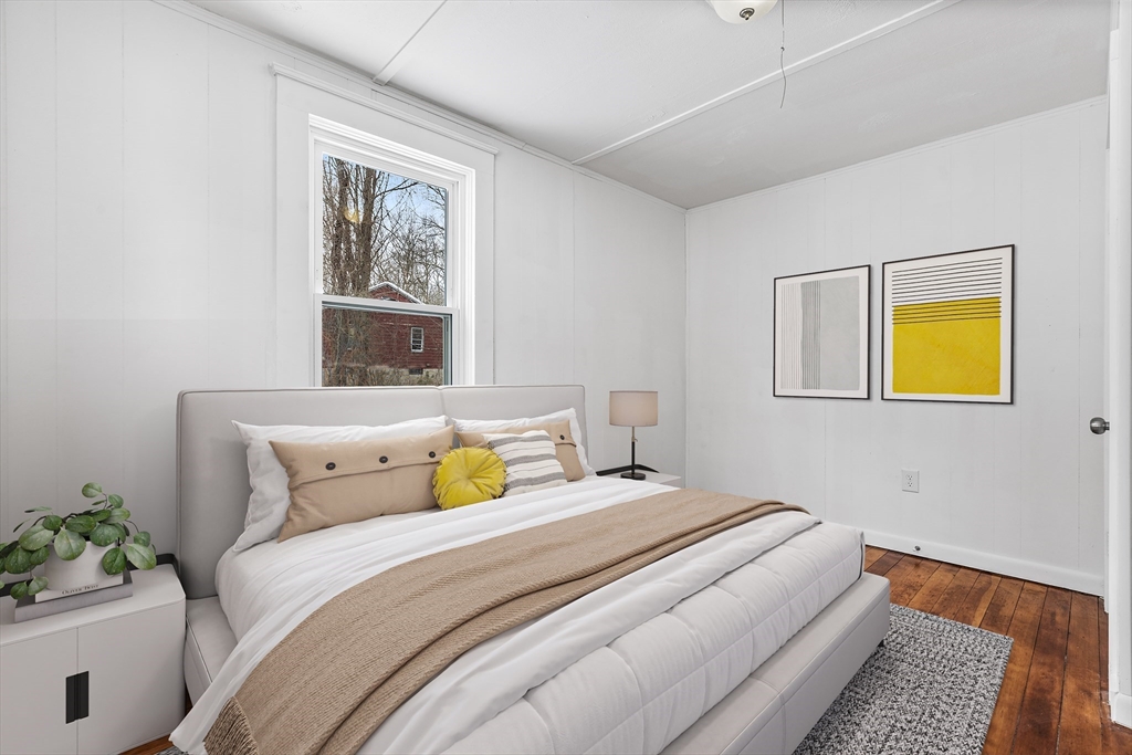 597 Mendon Road Northbridge, MA 01534 - Photo 8 of 13 a bedroom with a bed and a painting on the wall