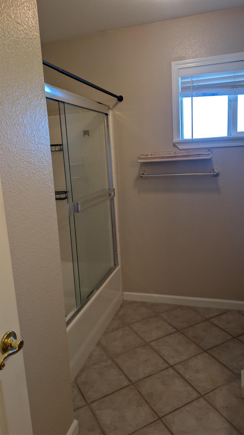 3248 Sudbury Road Cameron Park, CA 95682 - Photo 27 of 41 a bathroom with a glass shower door