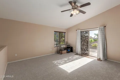 a view of a livingroom with a ceiling fan and window