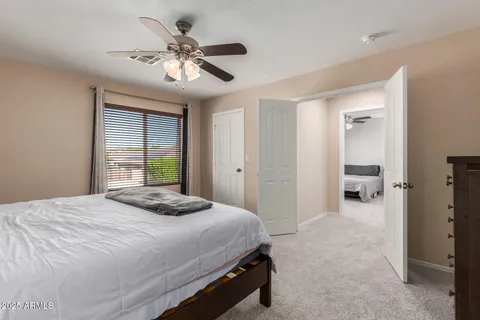 a bedroom with a large bed and a chandelier