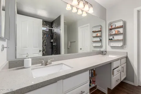 a bathroom with a sink double vanity and a mirror