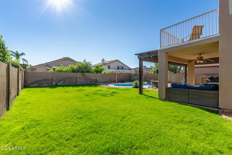 a view of an house with backyard space and balcony