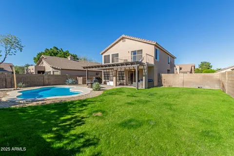 a view of house with yard and outdoor seating