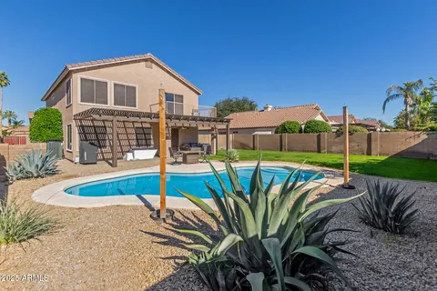 a view of a house with backyard and sitting area