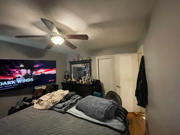 a bedroom with a bed and a flat screen tv