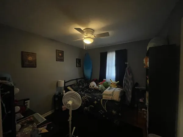 a room with furniture and chandelier fan