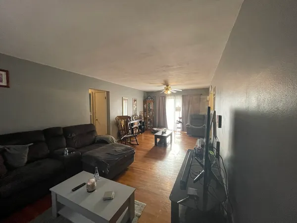 a living room with furniture and wooden floor