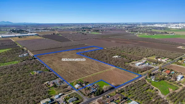 a view of a yard with wooden fence