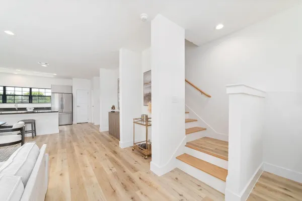a view of a bedroom with wooden floor and windows
