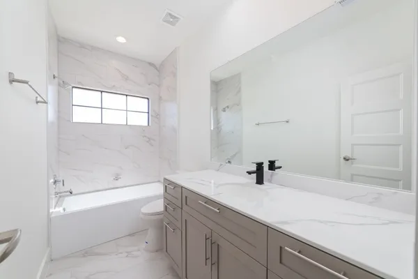a bathroom with a sink a toilet and bathtub