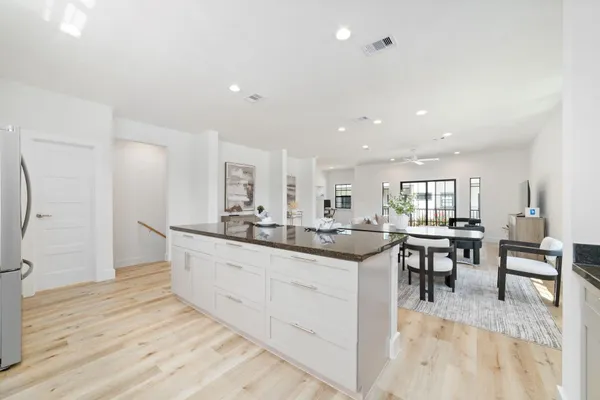 a kitchen with center island table and chairs