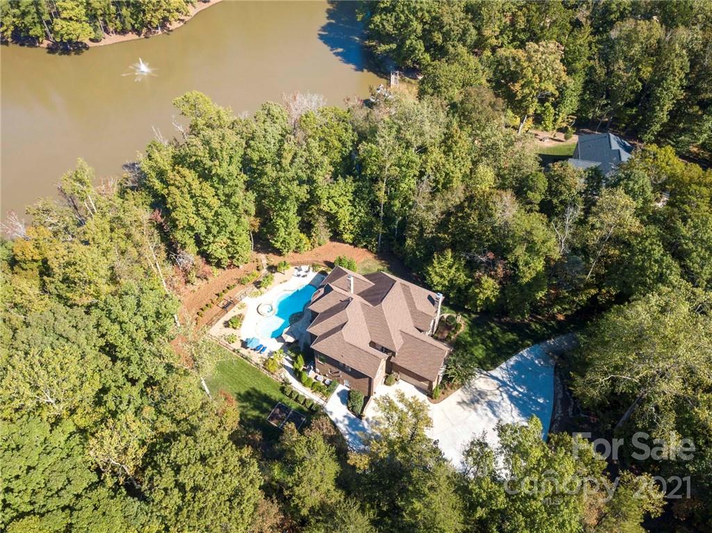 2130 Pondmeade Lane Matthews, NC 28104 - Photo 14 of 47 an aerial view of a house with a yard and lake view