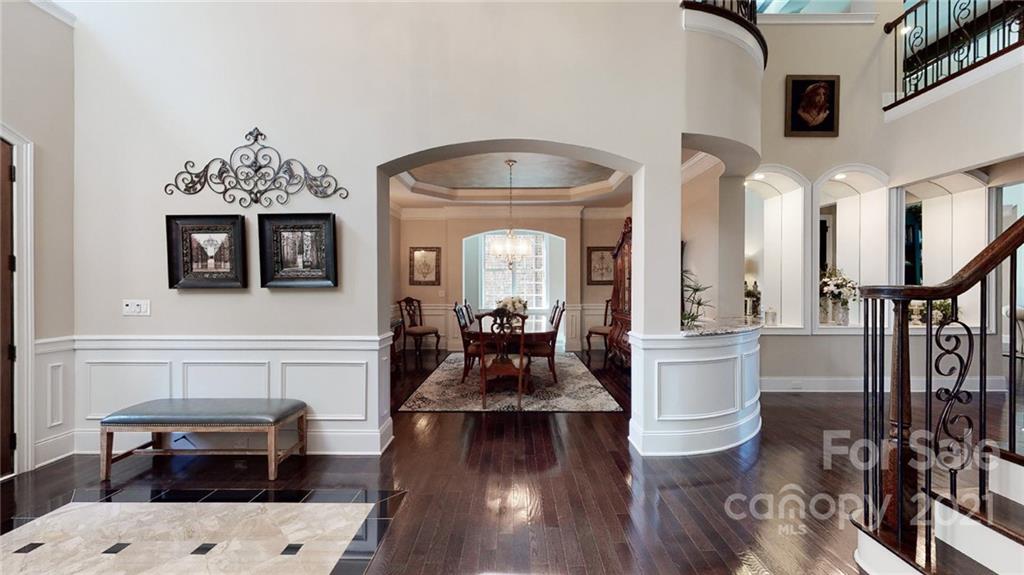 2130 Pondmeade Lane Matthews, NC 28104 - Photo 17 of 47 a living room with furniture a fireplace and a chandelier