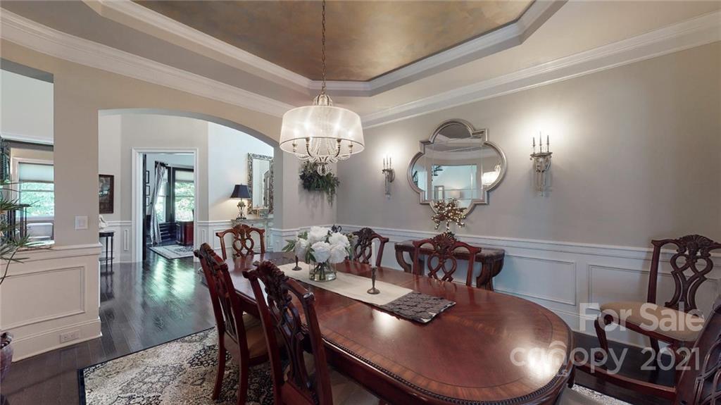 2130 Pondmeade Lane Matthews, NC 28104 - Photo 25 of 47 a view of a dining room with furniture and chandelier