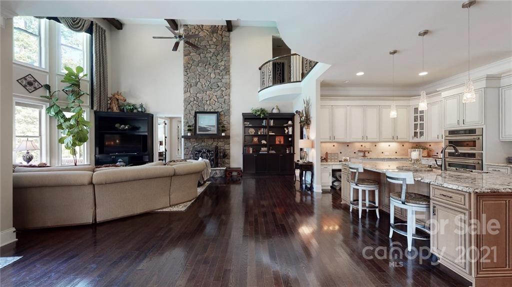 2130 Pondmeade Lane Matthews, NC 28104 - Photo 33 of 47 a living room with fireplace furniture and a wooden floor