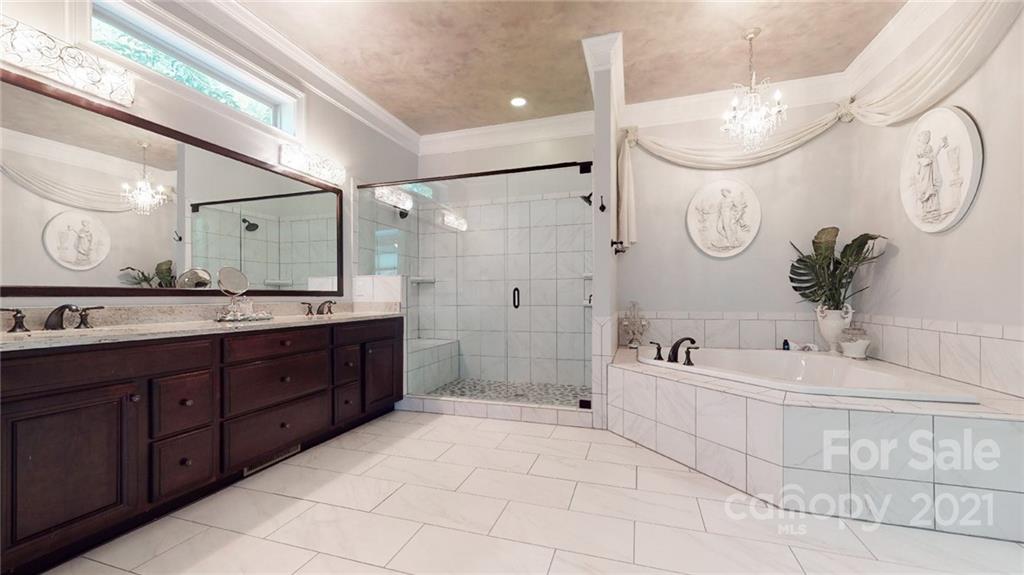2130 Pondmeade Lane Matthews, NC 28104 - Photo 39 of 47 a spacious bathroom with a double vanity sink mirror double and bathtub