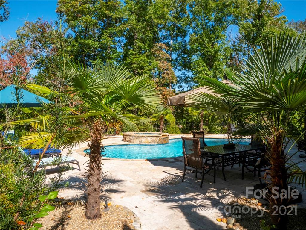 2130 Pondmeade Lane Matthews, NC 28104 - Photo 4 of 47 a backyard of a house with table and chairs