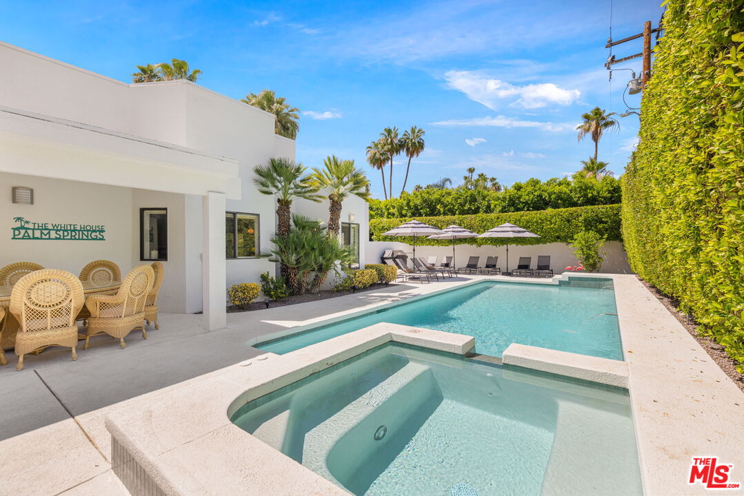 1414 Sagebrush Road Palm Springs, CA 92264 - Photo 42 of 48 a view of a swimming pool with furniture