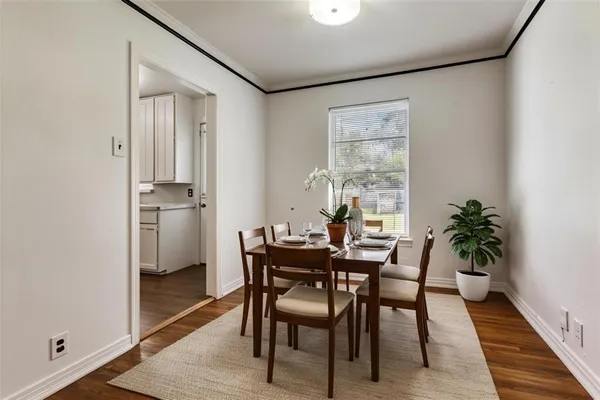 a view of a dining room with furniture and window