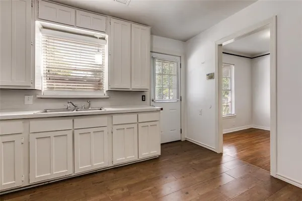 a kitchen with stainless steel appliances granite countertop a sink and dishwasher with wooden floor