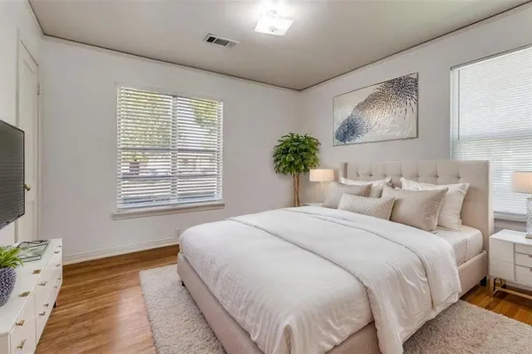 a bedroom with a large bed and a window
