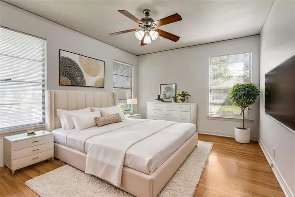 a bedroom with a large bed and a flat screen tv