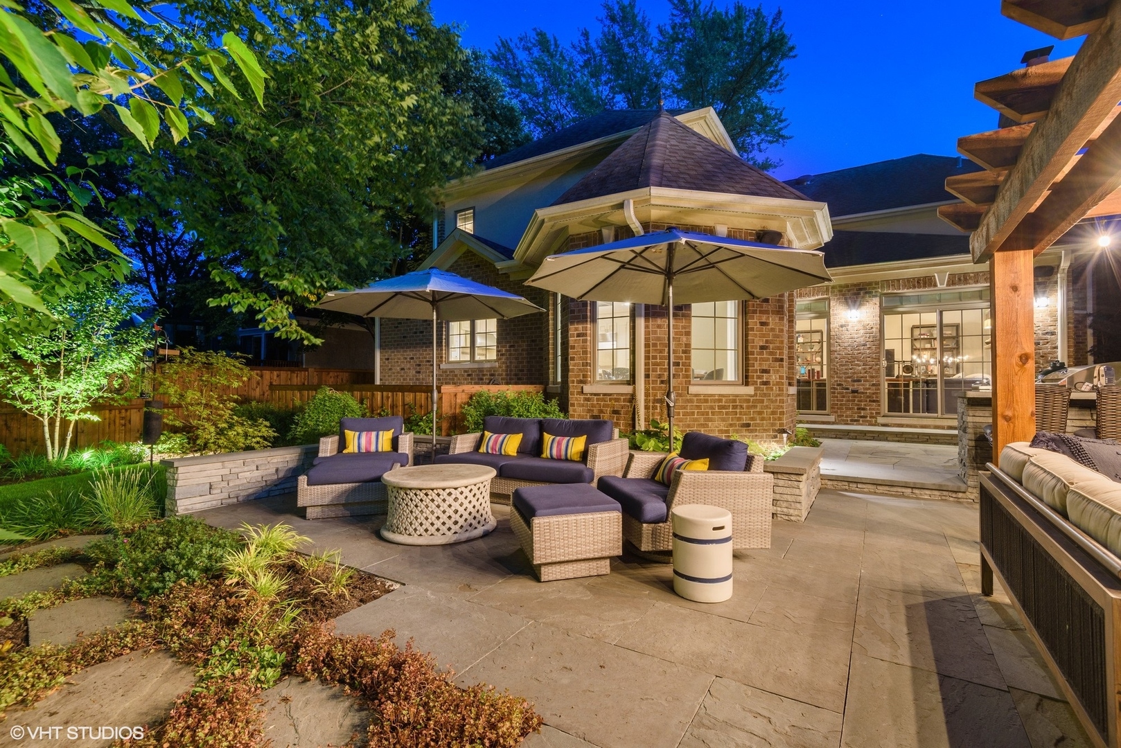 Undisclosed Address Wilmette, IL 60091 - Photo 4 of 57 a view of a patio with couches table and chairs under an umbrella