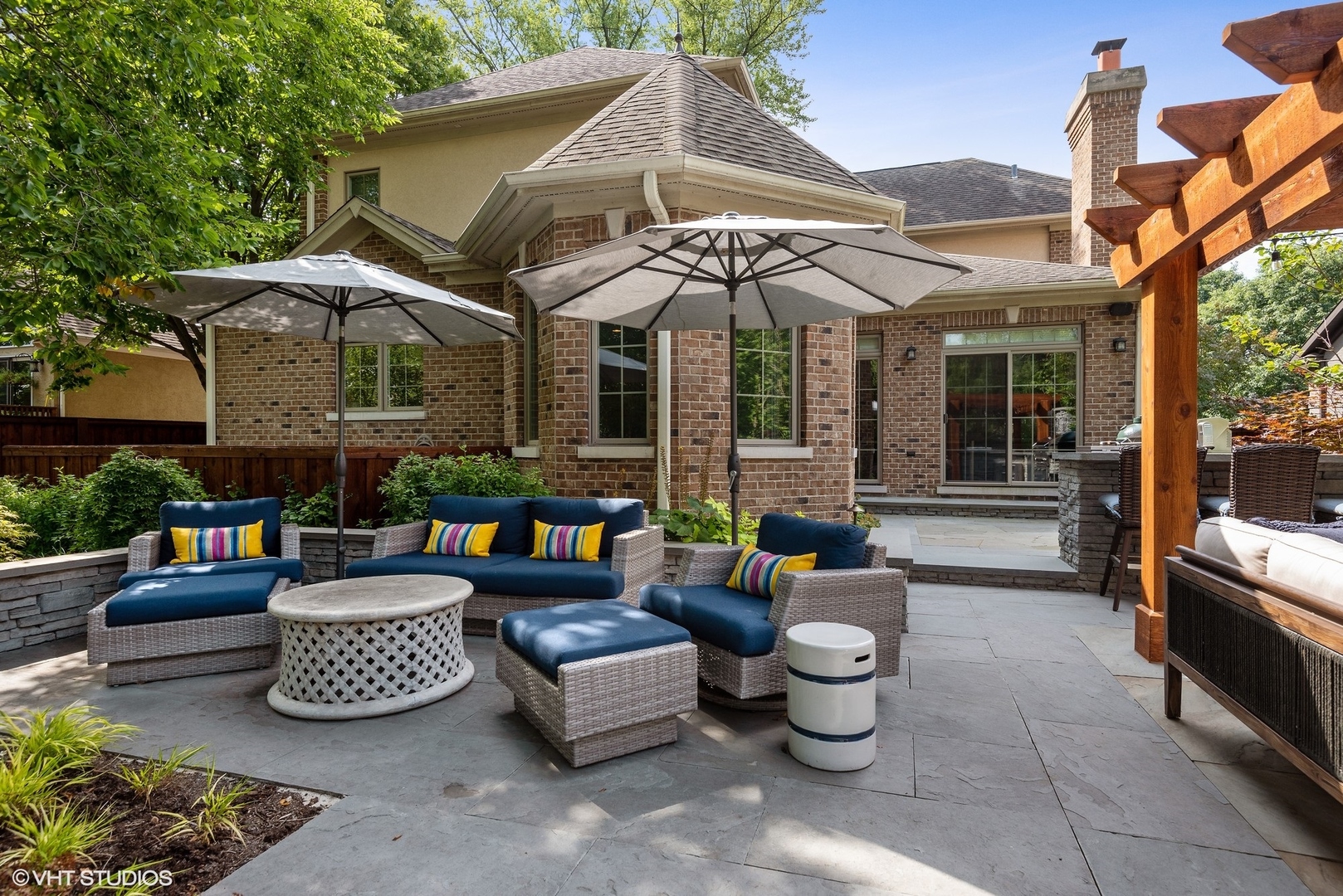 Undisclosed Address Wilmette, IL 60091 - Photo 47 of 57 a view of a patio with couches table and chairs under an umbrella