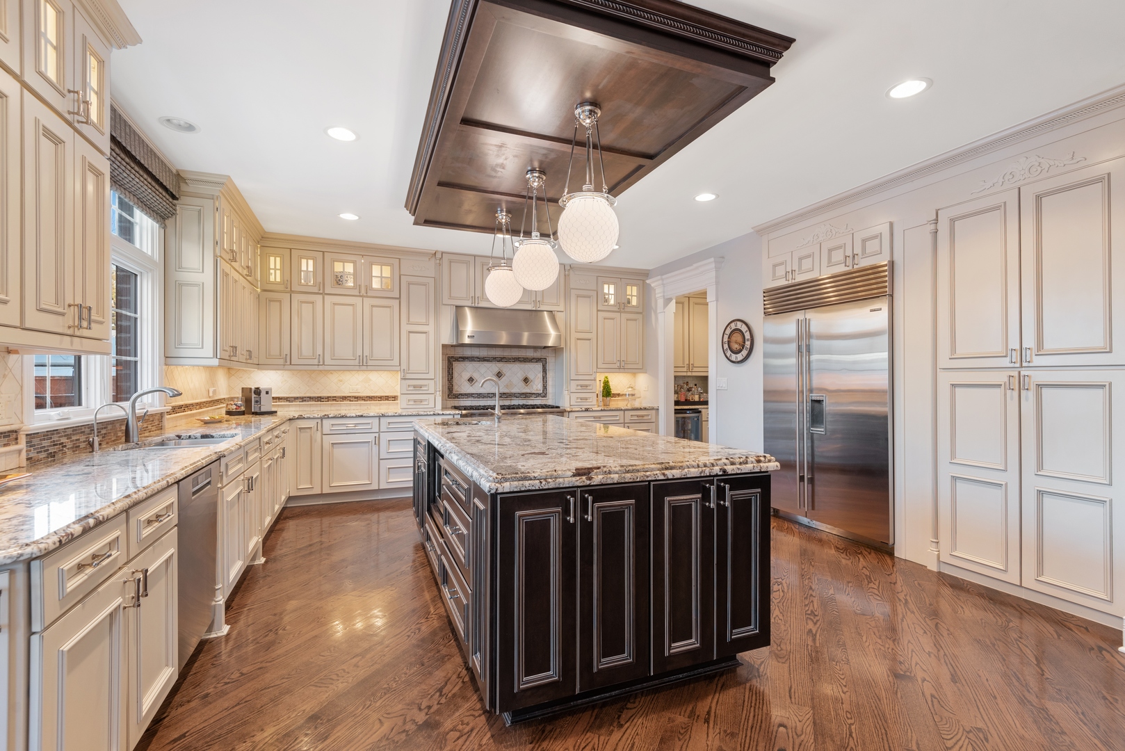 Undisclosed Address Wilmette, IL 60091 - Photo 9 of 57 a kitchen with stainless steel appliances granite countertop a stove a refrigerator a sink and white cabinets with wooden floor