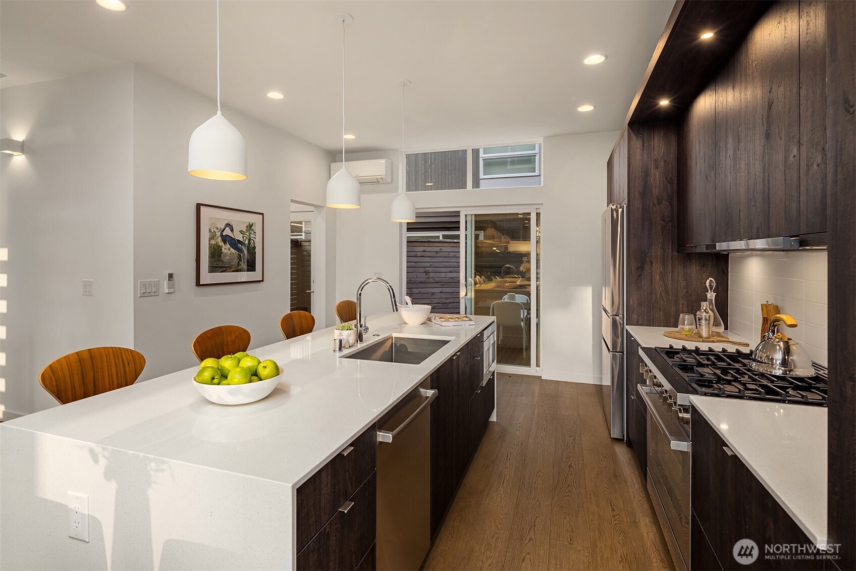 1910 8th Avenue West, Unit B Seattle, WA 98119 - Photo 11 of 40 a kitchen with stainless steel appliances granite countertop a sink a stove and a wooden floors
