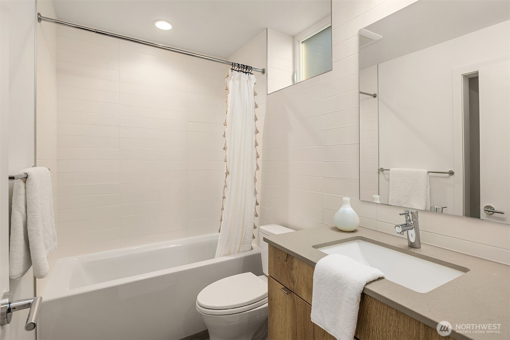 1910 8th Avenue West, Unit B Seattle, WA 98119 - Photo 27 of 40 a bathroom with a sink toilet vanity and shower