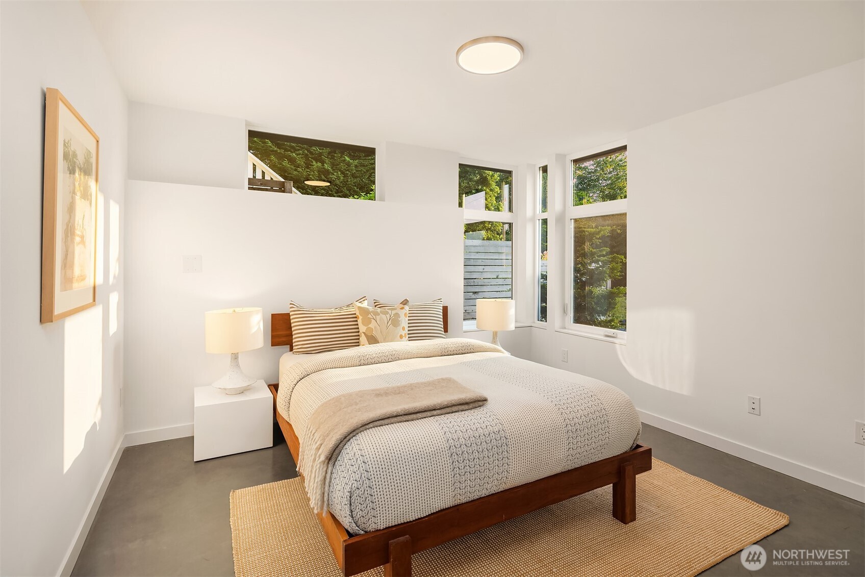 1910 8th Avenue West, Unit B Seattle, WA 98119 - Photo 31 of 40 a bedroom with a bed and a window