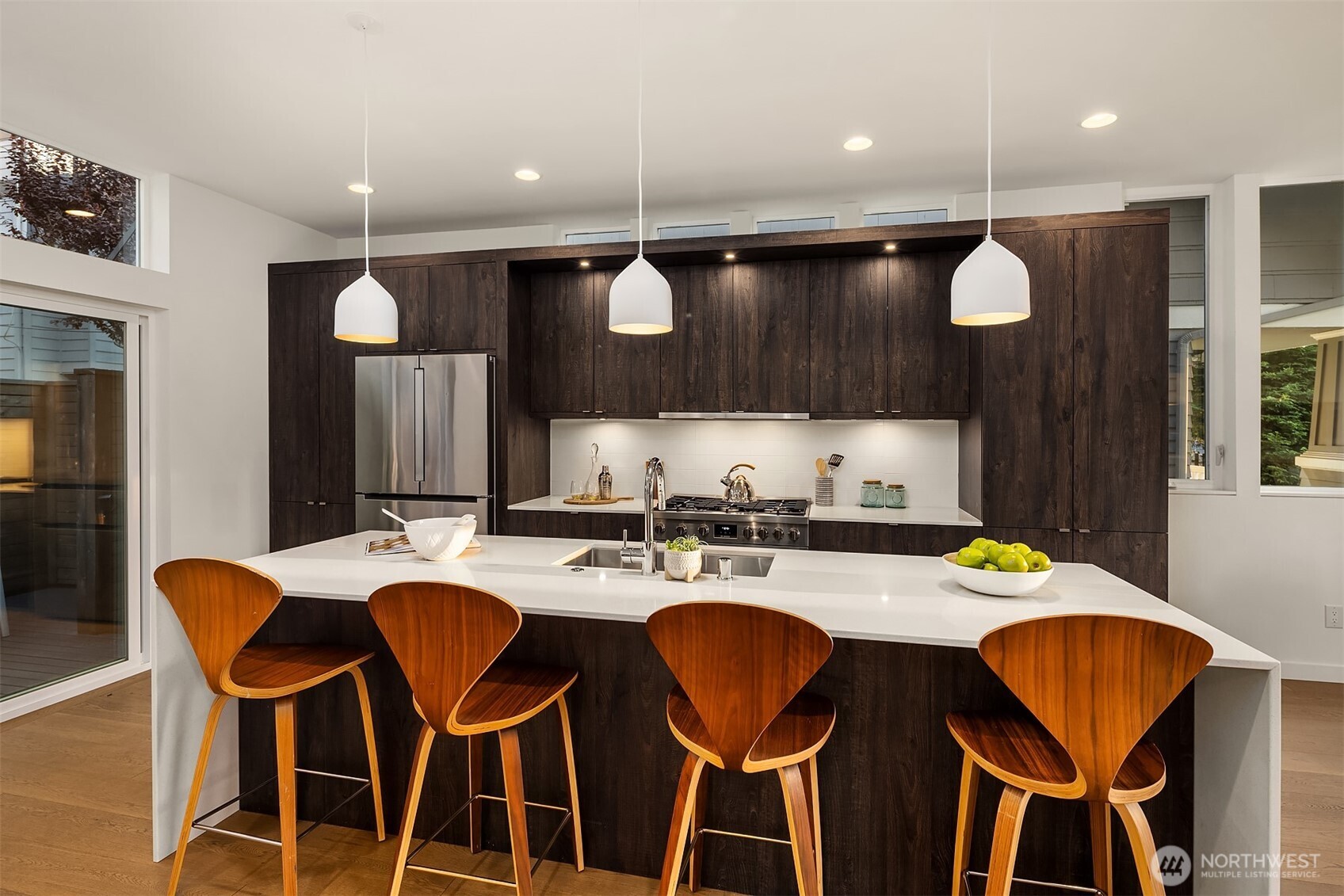 1910 8th Avenue West, Unit B Seattle, WA 98119 - Photo 10 of 40 a kitchen with a dining table chairs and sink