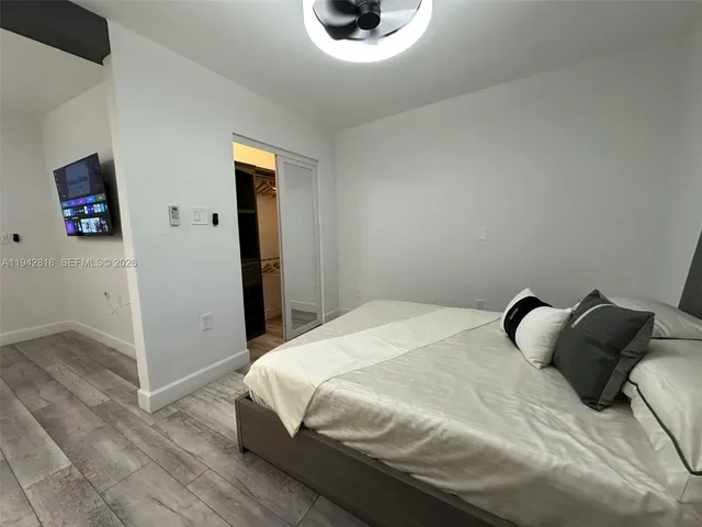 a bedroom with a bed and a chair