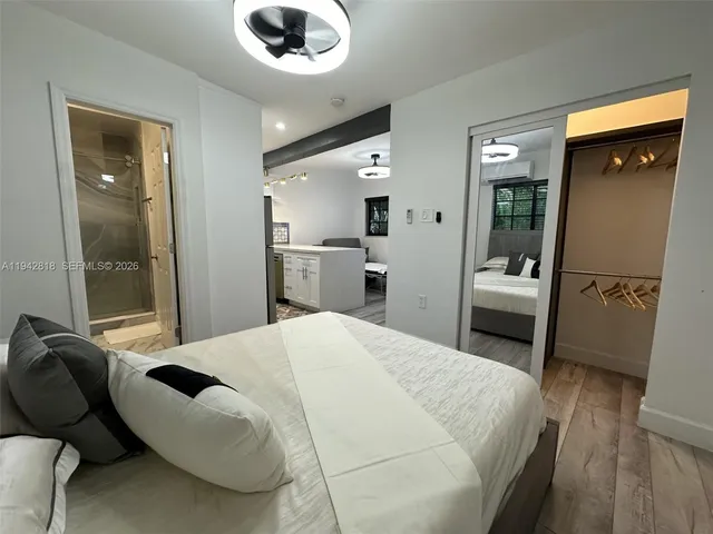 a large white bed in a white room