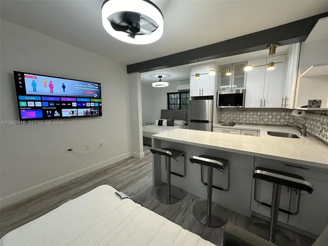 a kitchen with stainless steel appliances granite countertop a sink and a stove