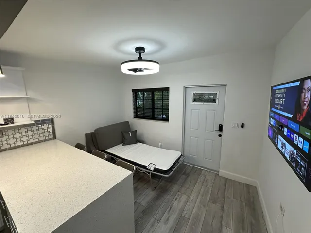 a bedroom with two beds and a flat screen tv