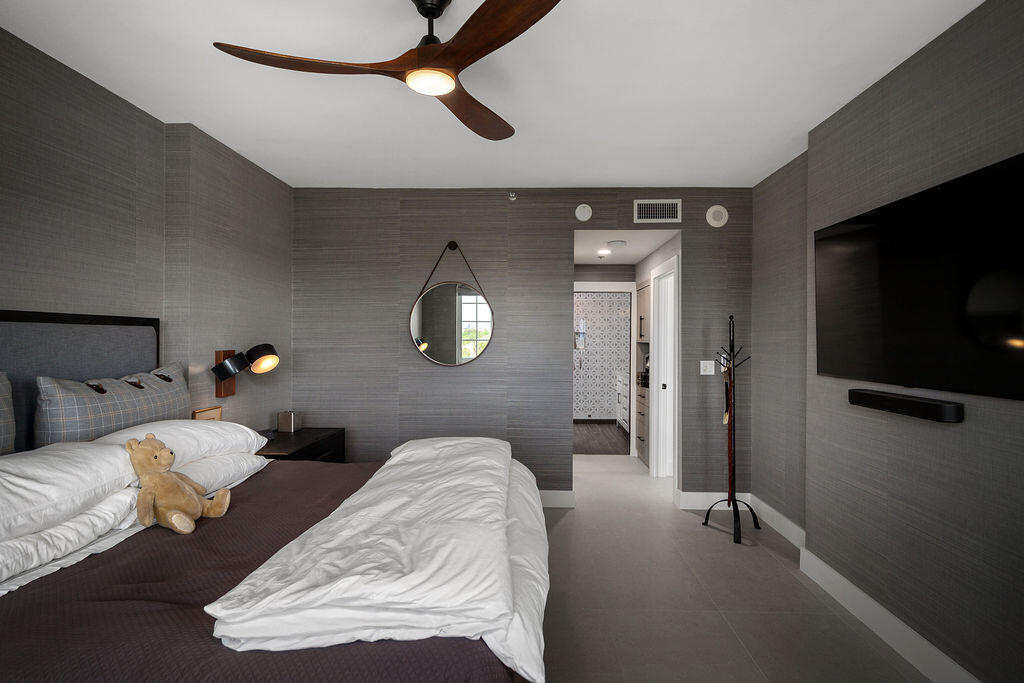 17031 Boca Club Boulevard, Unit 65A Boca Raton, FL 33487 - Photo 13 of 34 a living room with furniture and a flat screen tv