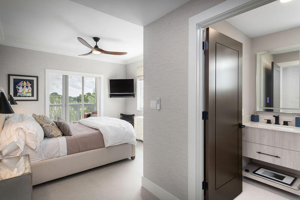 17031 Boca Club Boulevard, Unit 65A Boca Raton, FL 33487 - Photo 17 of 34 a bedroom with a bed and a chandelier